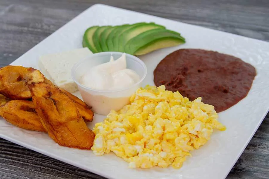 Eggs with avocado, ripe banana and sauce