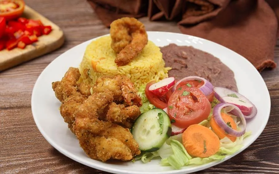 Salad with yellow rice, bean sauce and breaded meat 