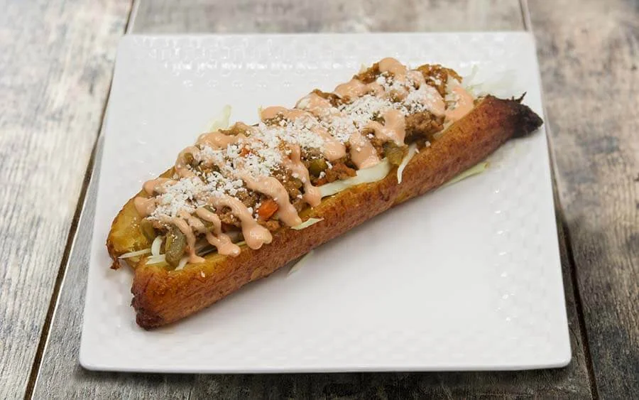 Ripe plantain stuffed with vegetables and sauce 