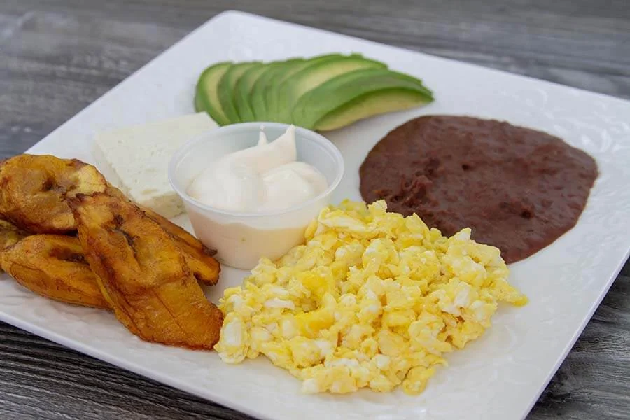 Eggs with avocado, ripe banana and sauce 