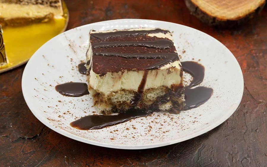 White dessert with a layer of chocolate and chocolate sauce 